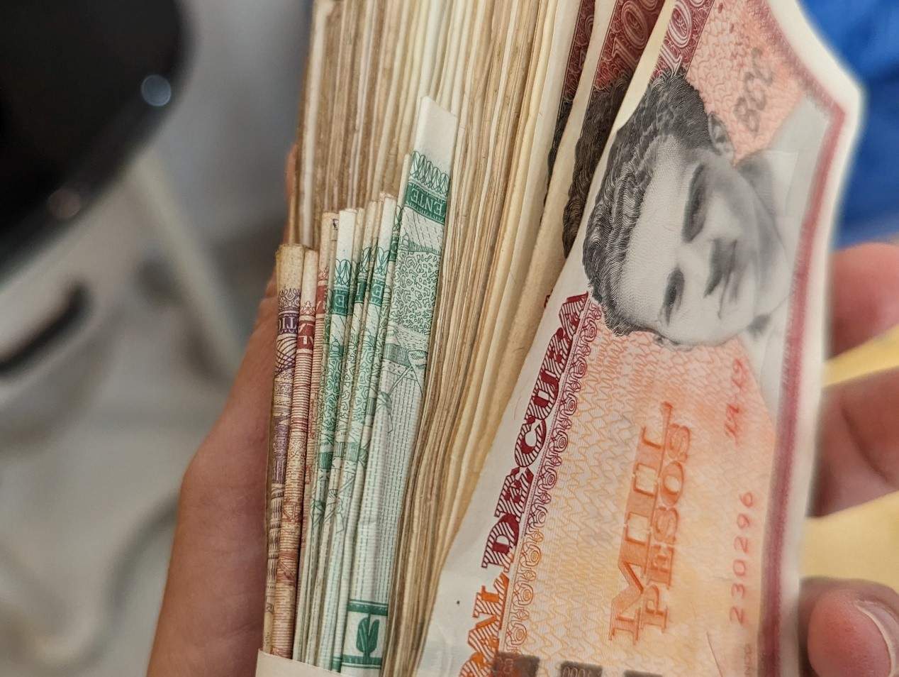 four thick stacks of money wrapped in newspaper four thick stacks of money wrapped in newspaper
