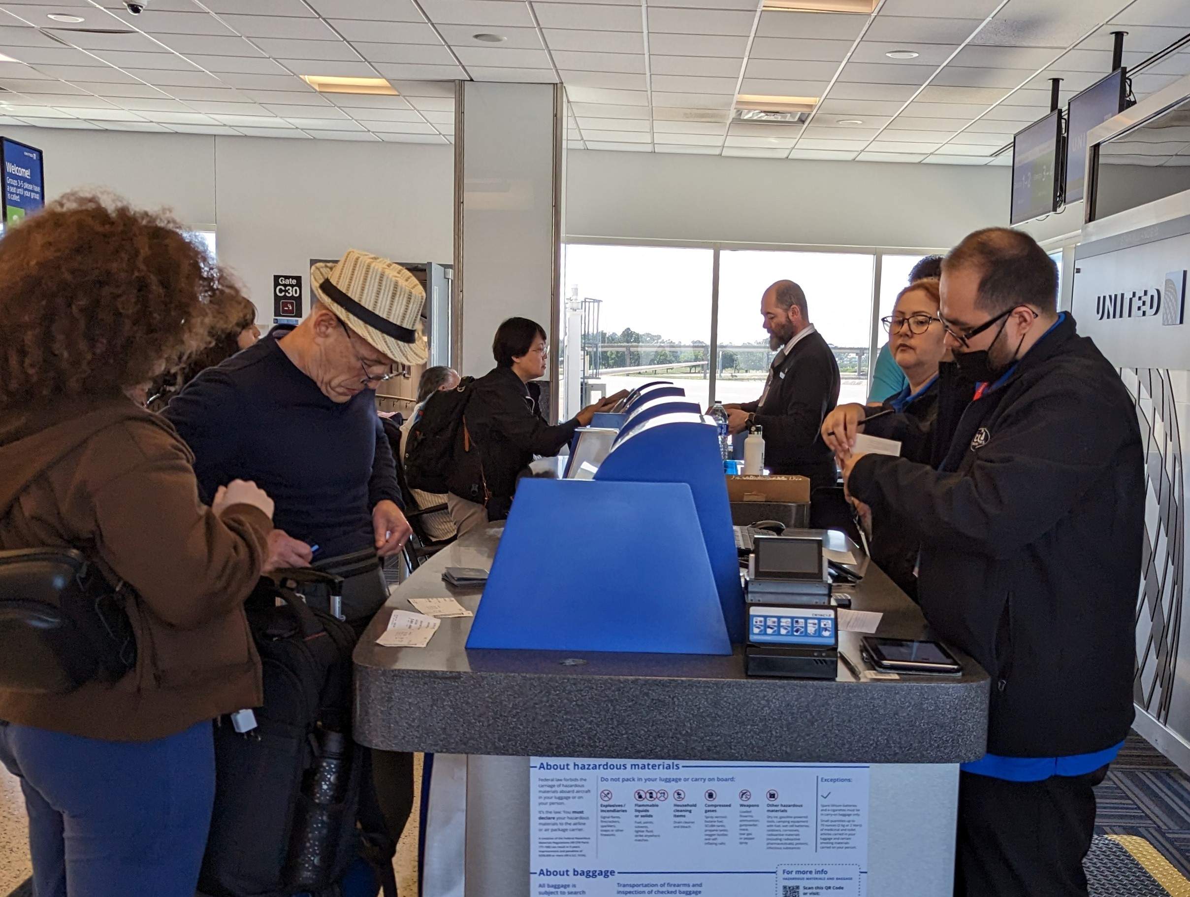 Passengers get documents checked at the airport
