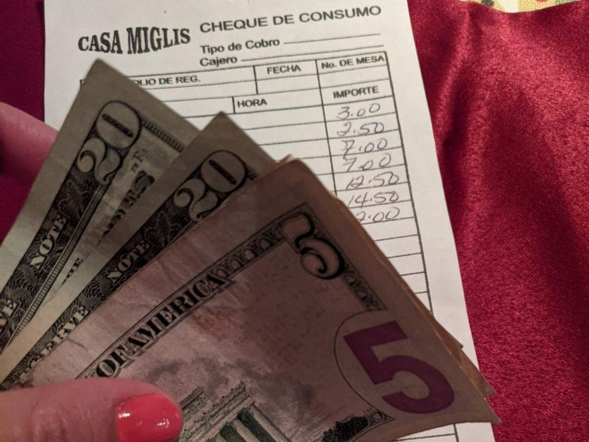US dollars above a restaurant bill US dollars above a restaurant bill