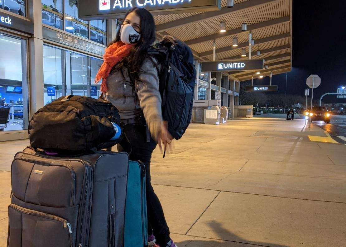 woman with large suitcases at airport